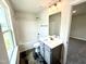 Well-lit bathroom featuring a vanity, toilet, shower with tub and sleek black floors at 122 Southern Estates Dr, Sanford, NC 27330