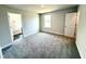 Bedroom with natural light, plush carpet, and easy access to the bathroom and closet at 122 Southern Estates Dr, Sanford, NC 27330
