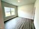 Bright, empty bedroom with a large window and neutral gray flooring at 122 Southern Estates Dr, Sanford, NC 27330