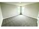 Bright bedroom with neutral carpeting, light walls, and windows letting in natural light at 122 Southern Estates Dr, Sanford, NC 27330