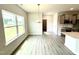 Dining area with large windows, stylish chandelier, and open view to the kitchen at 122 Southern Estates Dr, Sanford, NC 27330