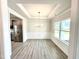 Bright dining room with wood floors, chair rail, and decorative tray ceiling at 122 Southern Estates Dr, Sanford, NC 27330