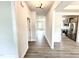 Hallway view showcasing gray wood floors leading to the kitchen and a living space at 122 Southern Estates Dr, Sanford, NC 27330