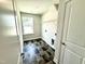 Laundry room with dark tile floors, one window, and wire rack above the washer/dryer hookups at 122 Southern Estates Dr, Sanford, NC 27330