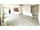 Open-concept living space with wood-look floors seamlessly flowing into the kitchen area at 122 Southern Estates Dr, Sanford, NC 27330