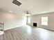 Bright living room with fireplace, ceiling fan, and beautiful wood-look floors at 122 Southern Estates Dr, Sanford, NC 27330