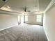 Spacious main bedroom with tray ceiling, plush carpet, and abundant natural light at 122 Southern Estates Dr, Sanford, NC 27330