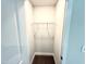 Compact walk-in closet featuring brown carpet floors and wire shelving for storage at 122 Southern Estates Dr, Sanford, NC 27330