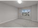 Well-lit bedroom with a window and carpeted floor at 130 Summerlin Dr, Clayton, NC 27527