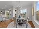 Breakfast nook with a round table, four chairs, and large windows overlooking the backyard at 130 Summerlin Dr, Clayton, NC 27527