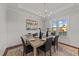 Formal dining room with hardwood floors, a chandelier, and large windows at 130 Summerlin Dr, Clayton, NC 27527