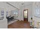 Bright entryway with hardwood floors, an elegant chandelier, and a view to the dining room at 130 Summerlin Dr, Clayton, NC 27527