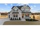 Two-story home with gray siding, landscaped yard, and a three-car garage at 130 Summerlin Dr, Clayton, NC 27527