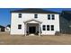 White house with a patio and two Adirondack chairs at 260 Chestnut Oak Ln, Lillington, NC 27546