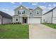Charming two-story home with well-manicured lawn and neutral colored siding at 270 Chestnut Oak Ln, Lillington, NC 27546