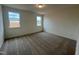 Simple bedroom with gray carpet and two windows at 234 Chestnut Oak Ln, Lillington, NC 27546