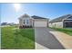 New single-story home with driveway and landscaped lawn at 234 Chestnut Oak Ln, Lillington, NC 27546