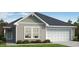 One-story home with a neutral exterior and two-car garage at 234 Chestnut Oak Ln, Lillington, NC 27546