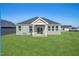 Gray house with a covered patio and green lawn at 234 Chestnut Oak Ln, Lillington, NC 27546