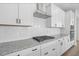 White kitchen features gas cooktop and granite countertops at 234 Chestnut Oak Ln, Lillington, NC 27546