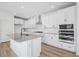 Modern kitchen with white cabinets, granite counters, and island at 234 Chestnut Oak Ln, Lillington, NC 27546