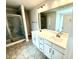 Bathroom featuring a double vanity with a large mirror and a glass-enclosed shower at 316 Bishop Ln, Sanford, NC 27330