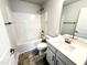 Bright bathroom featuring a shower-tub combo, white vanity, and sleek fixtures at 316 Bishop Ln, Sanford, NC 27330