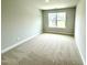 Neutral bedroom featuring carpet, light gray walls, and a bright window at 316 Bishop Ln, Sanford, NC 27330