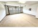 Spacious two-car garage with a concrete floor and a white garage door at 316 Bishop Ln, Sanford, NC 27330