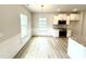 Eat in kitchen with white cabinets, stainless steel appliances and light wood floors at 316 Bishop Ln, Sanford, NC 27330