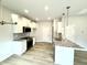 Modern kitchen featuring granite countertops, stainless steel appliances, and white cabinetry at 316 Bishop Ln, Sanford, NC 27330