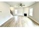 Living room with light wood floors, ceiling fan, fireplace, and neutral colored walls at 316 Bishop Ln, Sanford, NC 27330