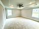 Spacious main bedroom with tray ceiling, neutral carpet, and two large windows at 316 Bishop Ln, Sanford, NC 27330