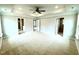 Spacious main bedroom featuring neutral walls, carpet and a stylish tray ceiling with fan at 316 Bishop Ln, Sanford, NC 27330
