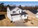 Two-story house, gray siding, white trim, two-car garage, and a small front yard at 395 Fast Pitch Ln, Four Oaks, NC 27524