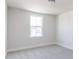 Cozy bedroom with neutral wall paint and carpet flooring, plus a large window at 395 Fast Pitch Ln, Four Oaks, NC 27524
