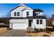 Two-story house with gray siding, white trim, and a two-car garage at 395 Fast Pitch Ln, Four Oaks, NC 27524