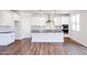 Modern kitchen with white cabinets, granite countertops, and a large island at 395 Fast Pitch Ln, Four Oaks, NC 27524