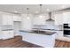 Modern kitchen with white cabinets, granite countertops, and a large island at 395 Fast Pitch Ln, Four Oaks, NC 27524