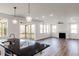 Bright living room with hardwood floors, fireplace, and access to screened porch at 395 Fast Pitch Ln, Four Oaks, NC 27524