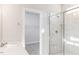 Bathroom with walk-in shower and marble tile at 411 Fast Pitch Ln, Four Oaks, NC 27524