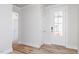 Bright entryway with white door and wood-look flooring at 411 Fast Pitch Ln, Four Oaks, NC 27524