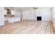 Open concept kitchen features white cabinets, granite countertops and island at 411 Fast Pitch Ln, Four Oaks, NC 27524