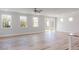 Spacious living area with hardwood floors and access to screened porch at 411 Fast Pitch Ln, Four Oaks, NC 27524