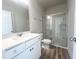 Modern bathroom featuring a glass-enclosed shower, vanity, and contemporary fixtures at 427 Fast Pitch Ln, Four Oaks, NC 27524