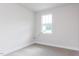 Clean, carpeted bedroom with a large window at 427 Fast Pitch Ln, Four Oaks, NC 27524