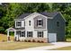 Beautiful two-story home featuring a lush green lawn, stone accents, and an attached garage at 427 Fast Pitch Ln, Four Oaks, NC 27524