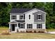 Charming two-story home with gray siding, black shutters, and a well-manicured front lawn at 427 Fast Pitch Ln, Four Oaks, NC 27524