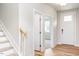 Inviting foyer with wood floors and a view into other rooms at 427 Fast Pitch Ln, Four Oaks, NC 27524