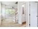 Bright foyer with hardwood floors, an open staircase, and a view into the living area at 427 Fast Pitch Ln, Four Oaks, NC 27524